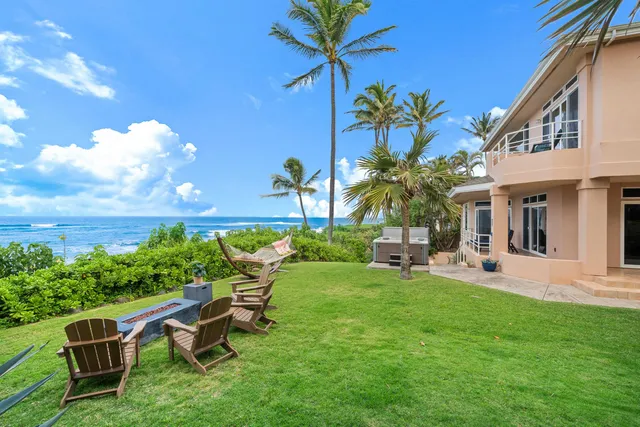 a view of a house with backyard sitting area and garden