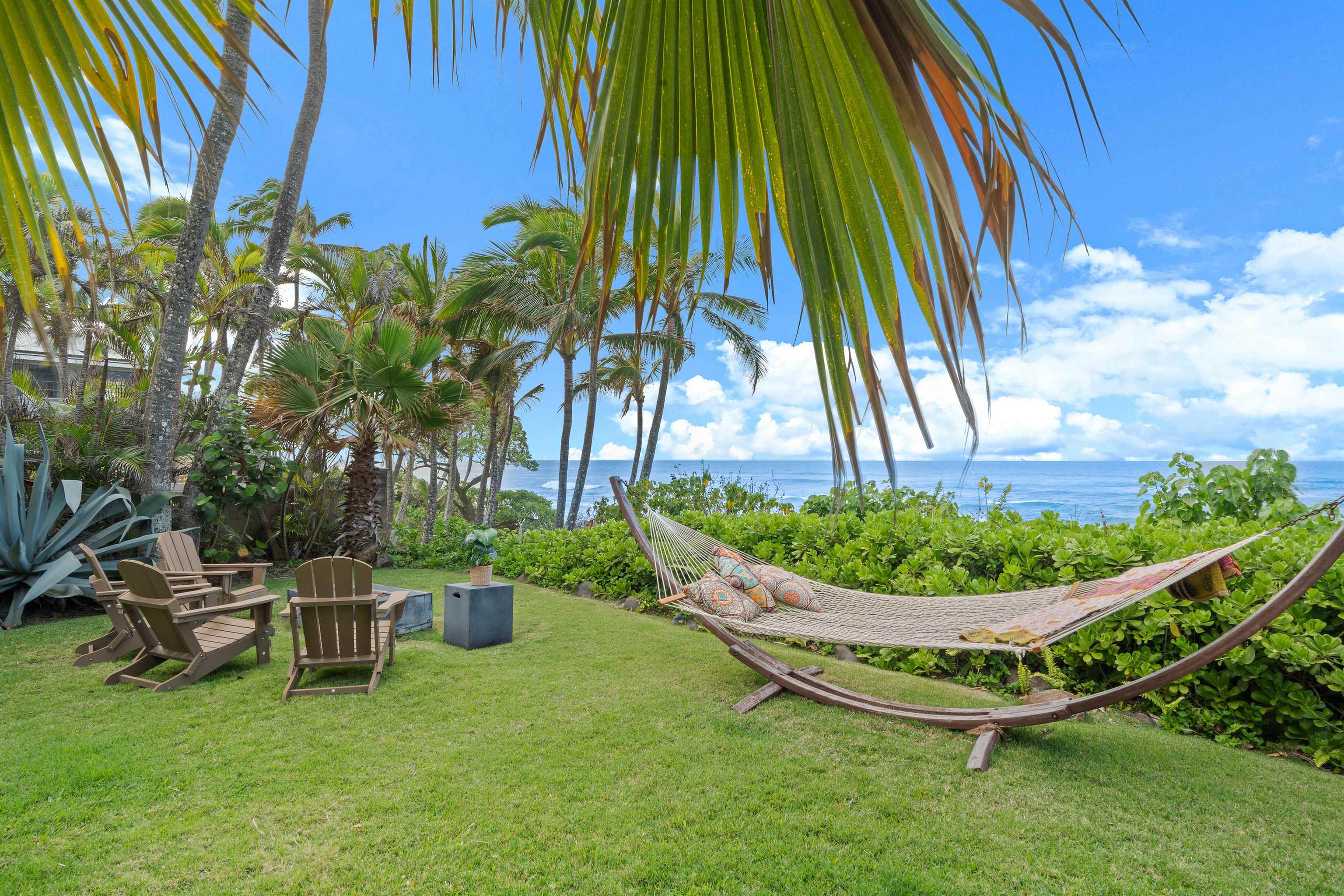 111 Aleiki Place Paia, HI 96779 - Photo 37 of 50 a view of a swimming pool with a bench and lawn chairs