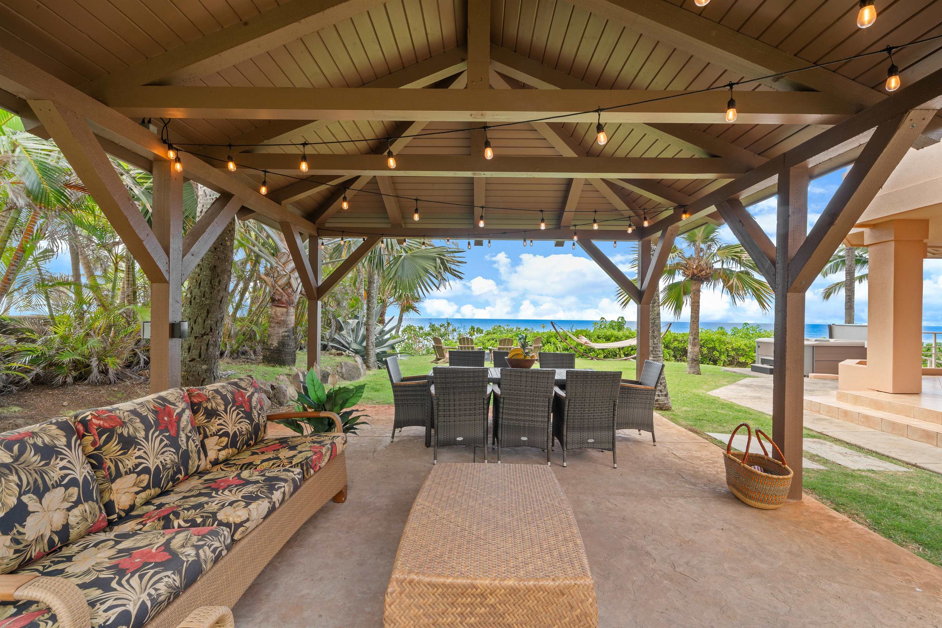111 Aleiki Place Paia, HI 96779 - Photo 43 of 50 a view of a patio with table and chairs under an umbrella with a small yard
