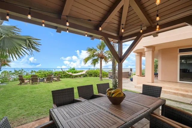 a view of a house with a yard and a patio