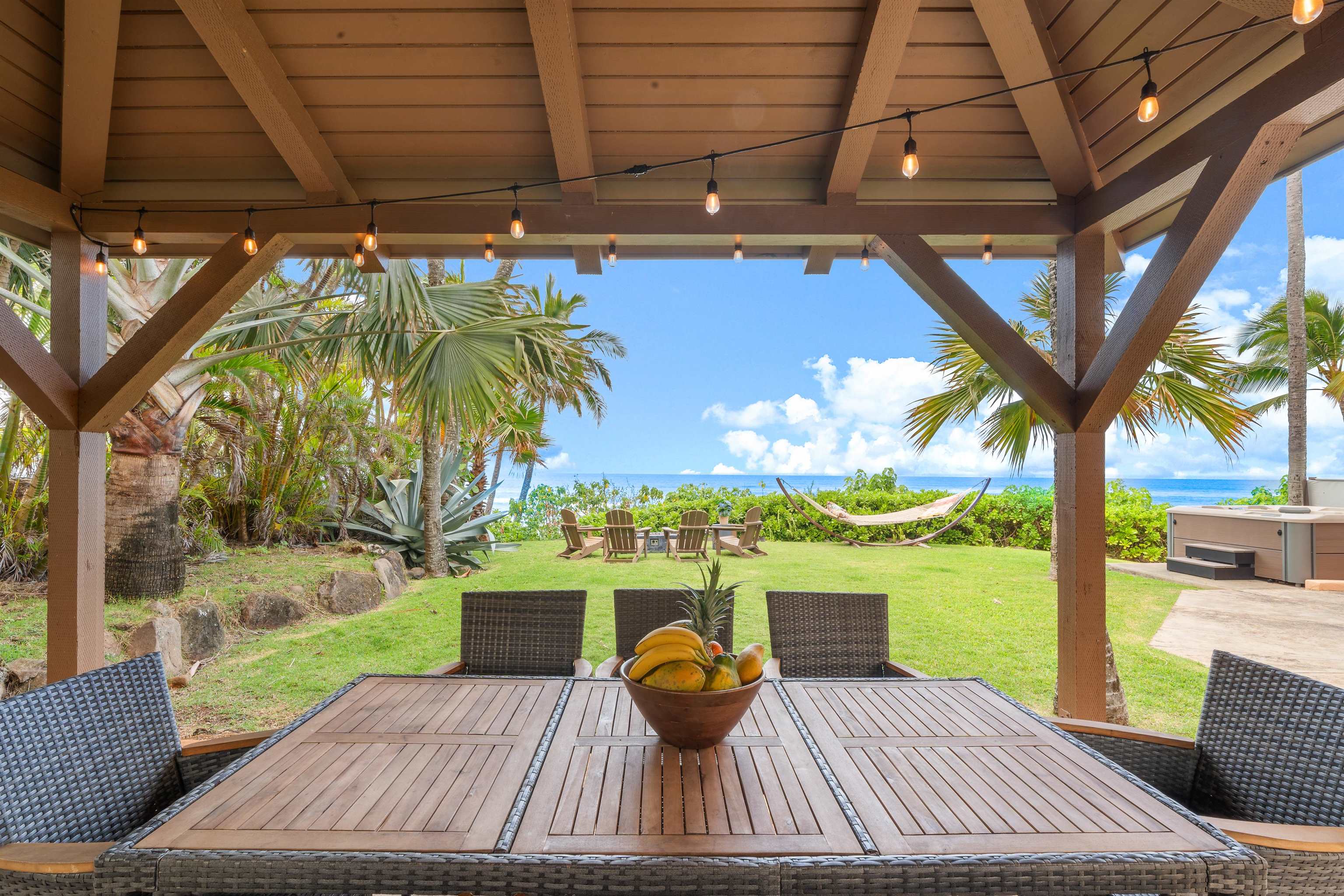 111 Aleiki Place Paia, HI 96779 - Photo 45 of 50 a view of a patio with lawn chairs under an umbrella