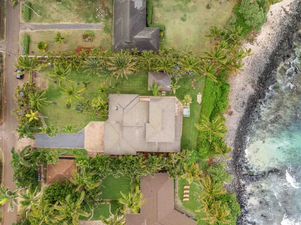 an aerial view of a residential house with a yard