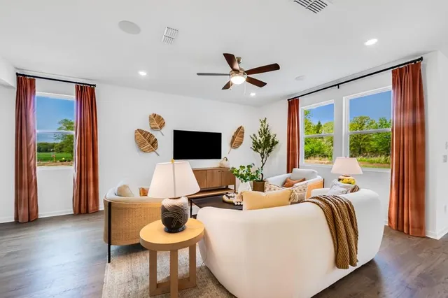 a kitchen with stainless steel appliances granite countertop a stove a sink dishwasher a dining table and chairs with wooden floor