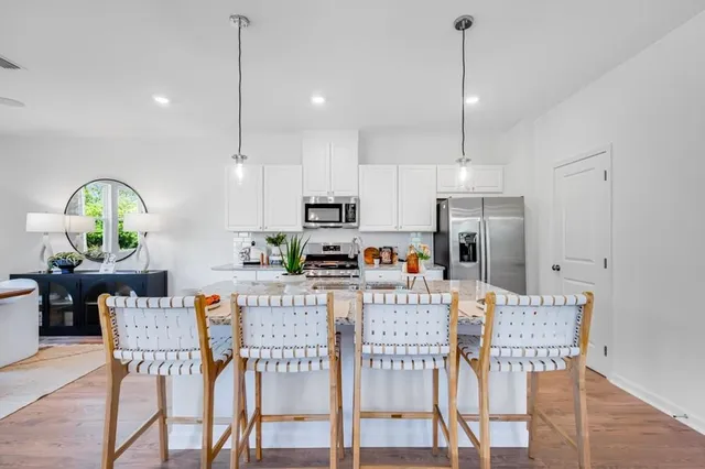 a living room filled with furniture and a potted plant