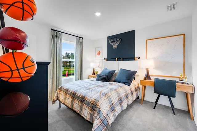 a bedroom with a bed and a painting on the wall