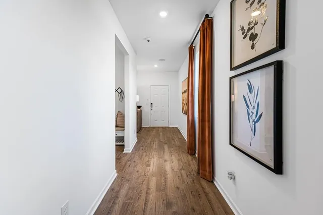 a living room with furniture a flat screen tv and a large window