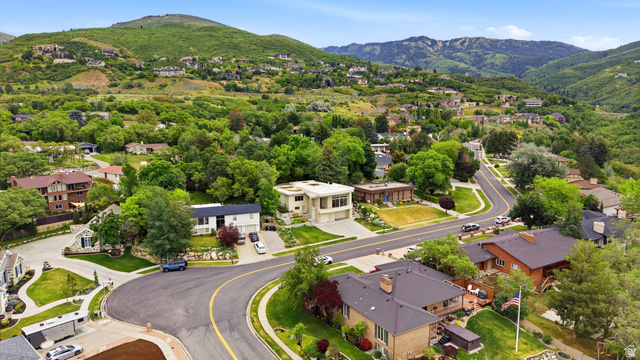 1389 Millbrook Way Bountiful, UT 84010 - Photo 74 of 74 Residential area featuring winding roads, mature trees, and mountainous terrain in the background