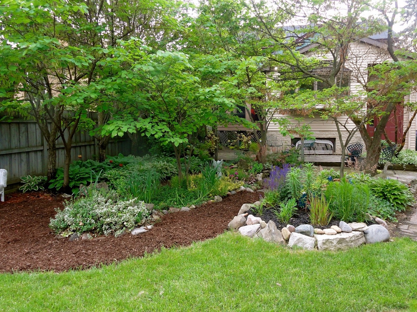 145 Woodside Road Riverside, IL 60546 - Photo 21 of 26 a view of a garden with plants and large trees