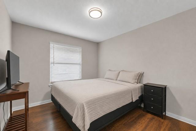 10124 Bunting Drive Waco, TX 76708 - Photo 13 of 18 a bedroom with a bed and a tv on table