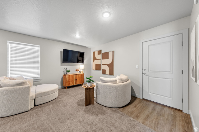 6231 Winding Way, Unit K105 Hurricane, UT 84737 - Photo 4 of 20 Living area with light wood finished floors and a textured ceiling