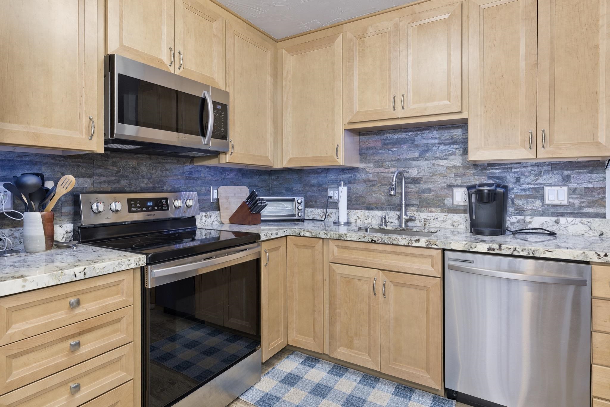 286 Old Mammoth Road, Unit 37 Mammoth Lakes, CA 93546 - Photo 15 of 33 Kitchen featuring stainless steel appliances, light wood finish cabinetry, and tasteful backsplash