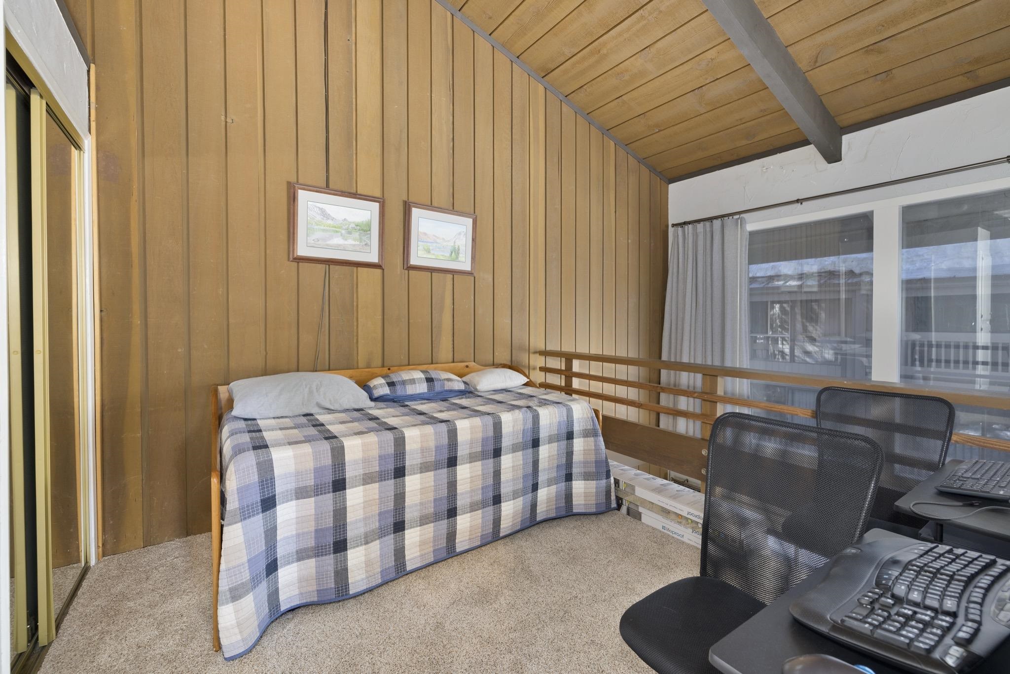 286 Old Mammoth Road, Unit 37 Mammoth Lakes, CA 93546 - Photo 17 of 33 Bedroom featuring carpet flooring, vaulted ceiling with beams, a closet, wood walls, and wooden ceiling