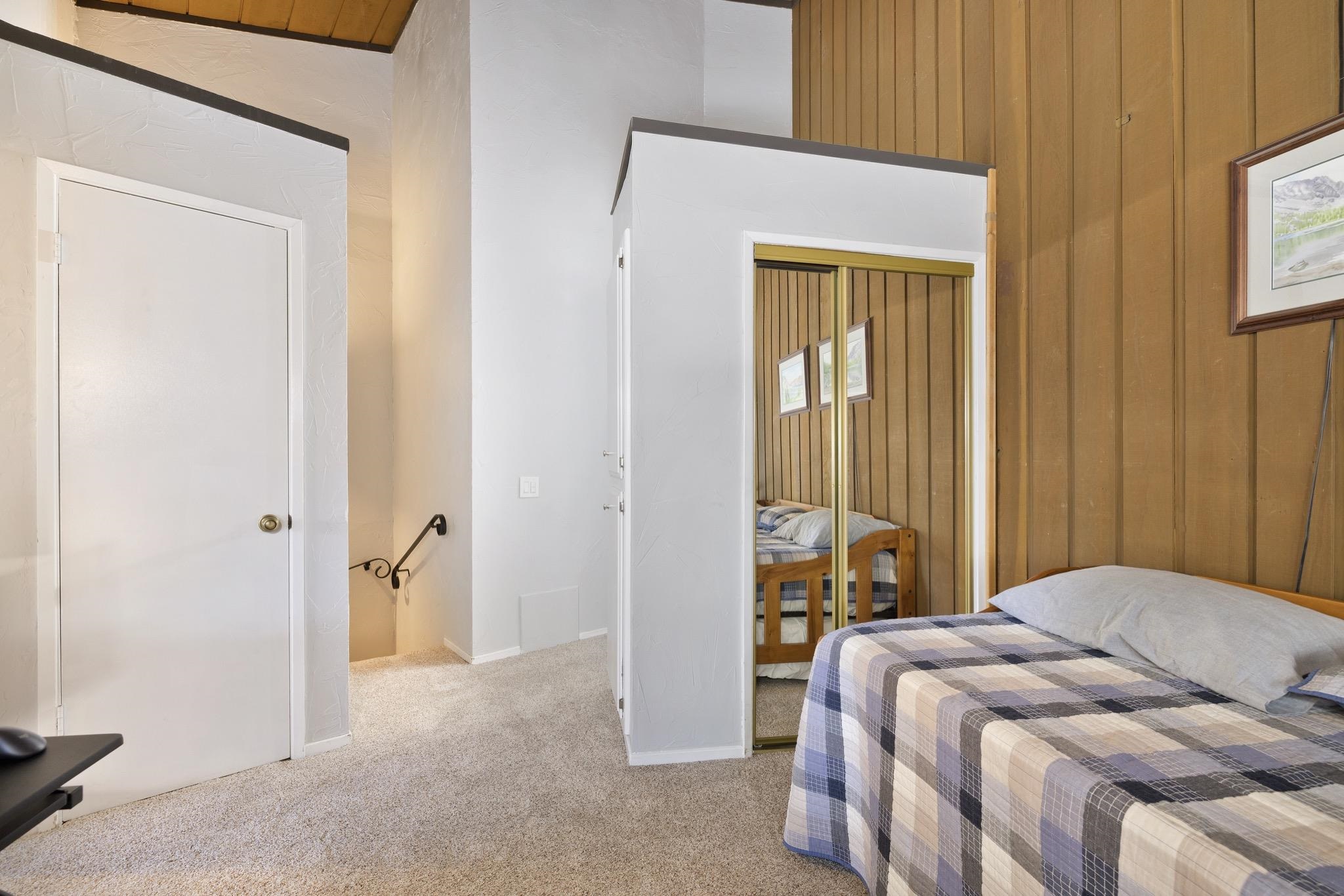 286 Old Mammoth Road, Unit 37 Mammoth Lakes, CA 93546 - Photo 18 of 33 Bedroom featuring light carpet, a closet, and wooden walls