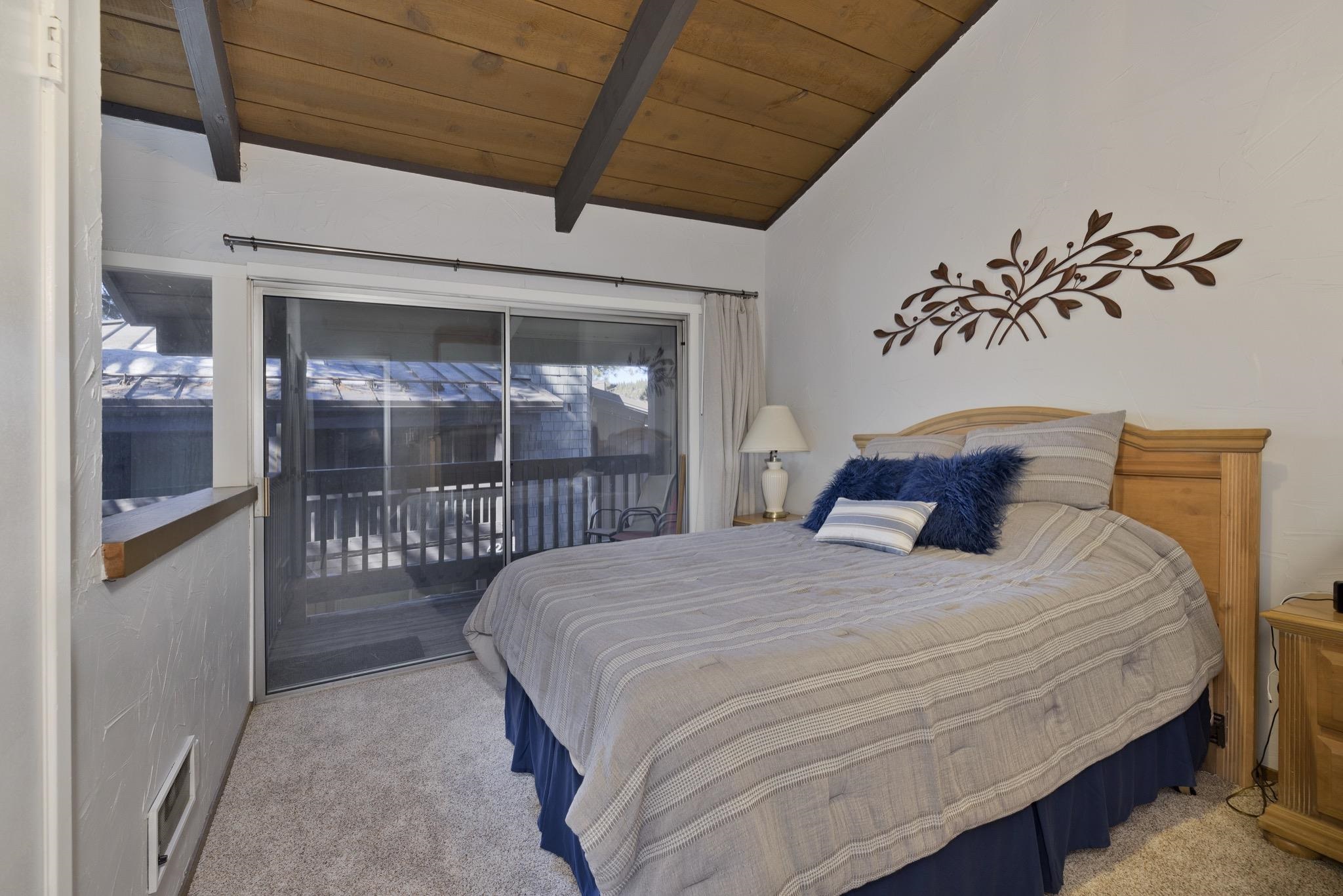 286 Old Mammoth Road, Unit 37 Mammoth Lakes, CA 93546 - Photo 21 of 33 Bedroom featuring light colored carpet, vaulted ceiling with beams, wooden ceiling, and access to exterior