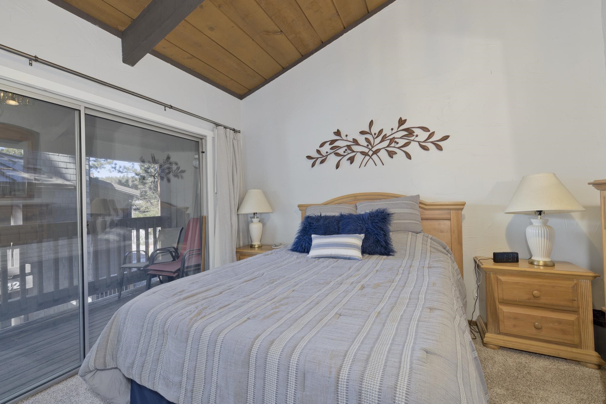 286 Old Mammoth Road, Unit 37 Mammoth Lakes, CA 93546 - Photo 22 of 33 Carpeted bedroom featuring vaulted ceiling with beams, wooden ceiling, and access to exterior