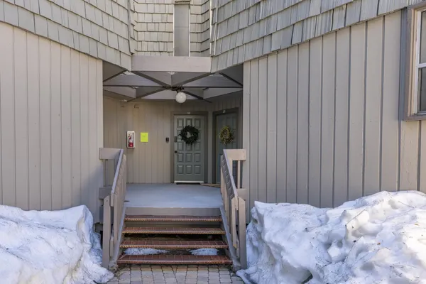 a view of a backyard with a small cabin and a chair