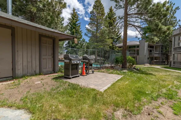 a view of a backyard with furniture and a fire pit