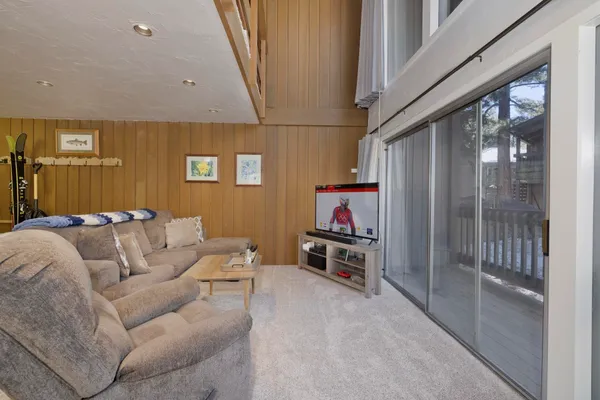 a living room with furniture and kitchen view