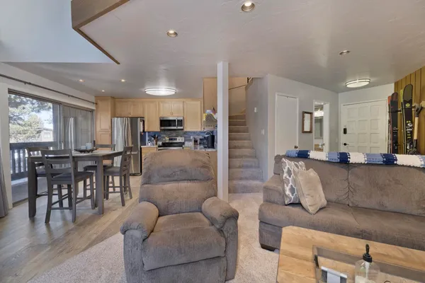 a kitchen with granite countertop a stove refrigerator and microwave
