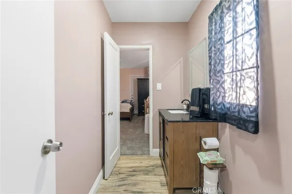 a bathroom with a tub sink and mirror