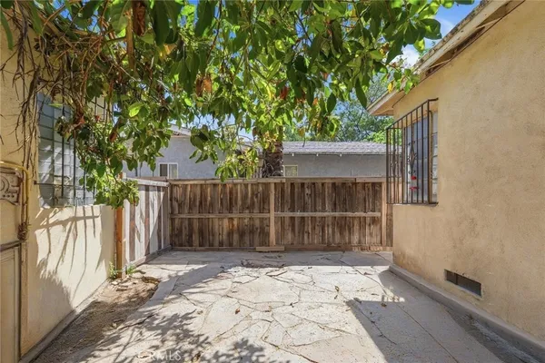 a front view of a house with a yard and potted plants