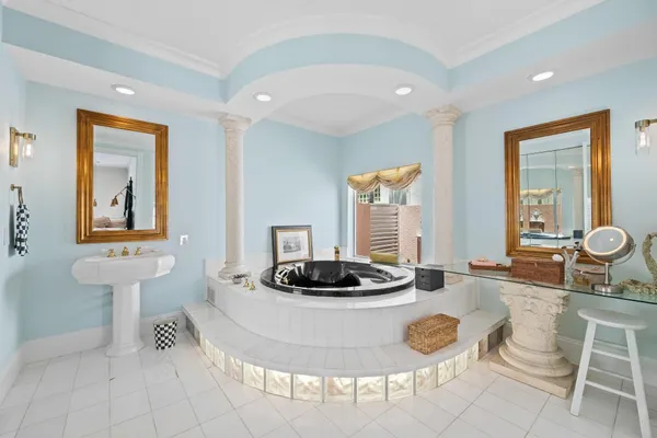a bathroom with a shower sink vanity mirror and toilet