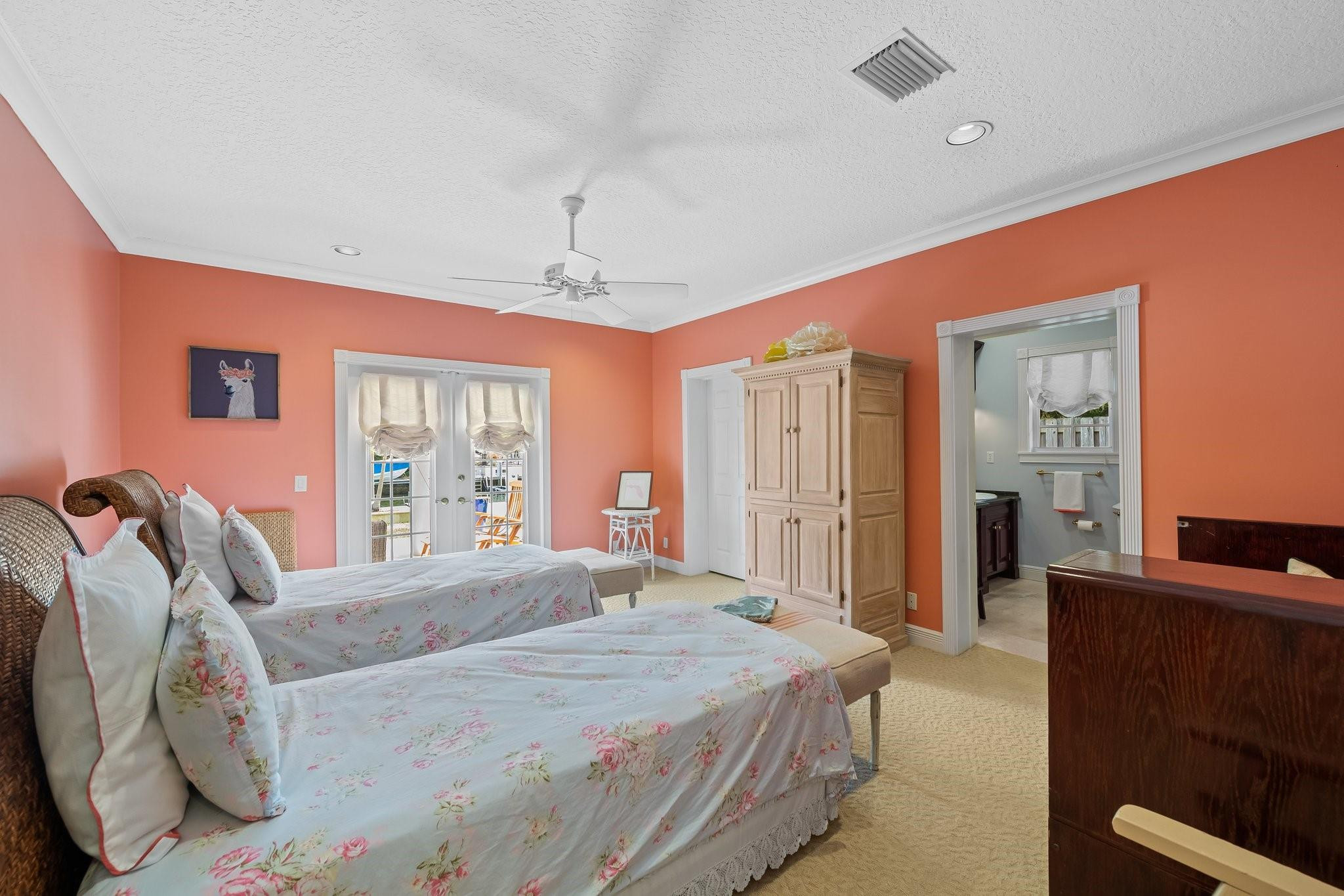 2342 Northeast 26th Street Lighthouse Point, FL 33064 - Photo 18 of 33 a bedroom with a bed and a dresser