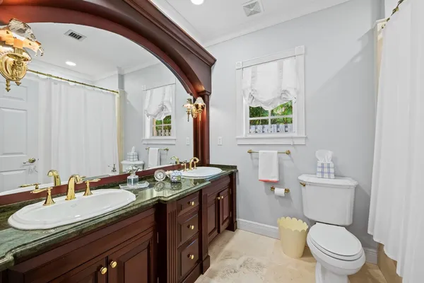 a kitchen with granite countertop a sink stove and cabinets