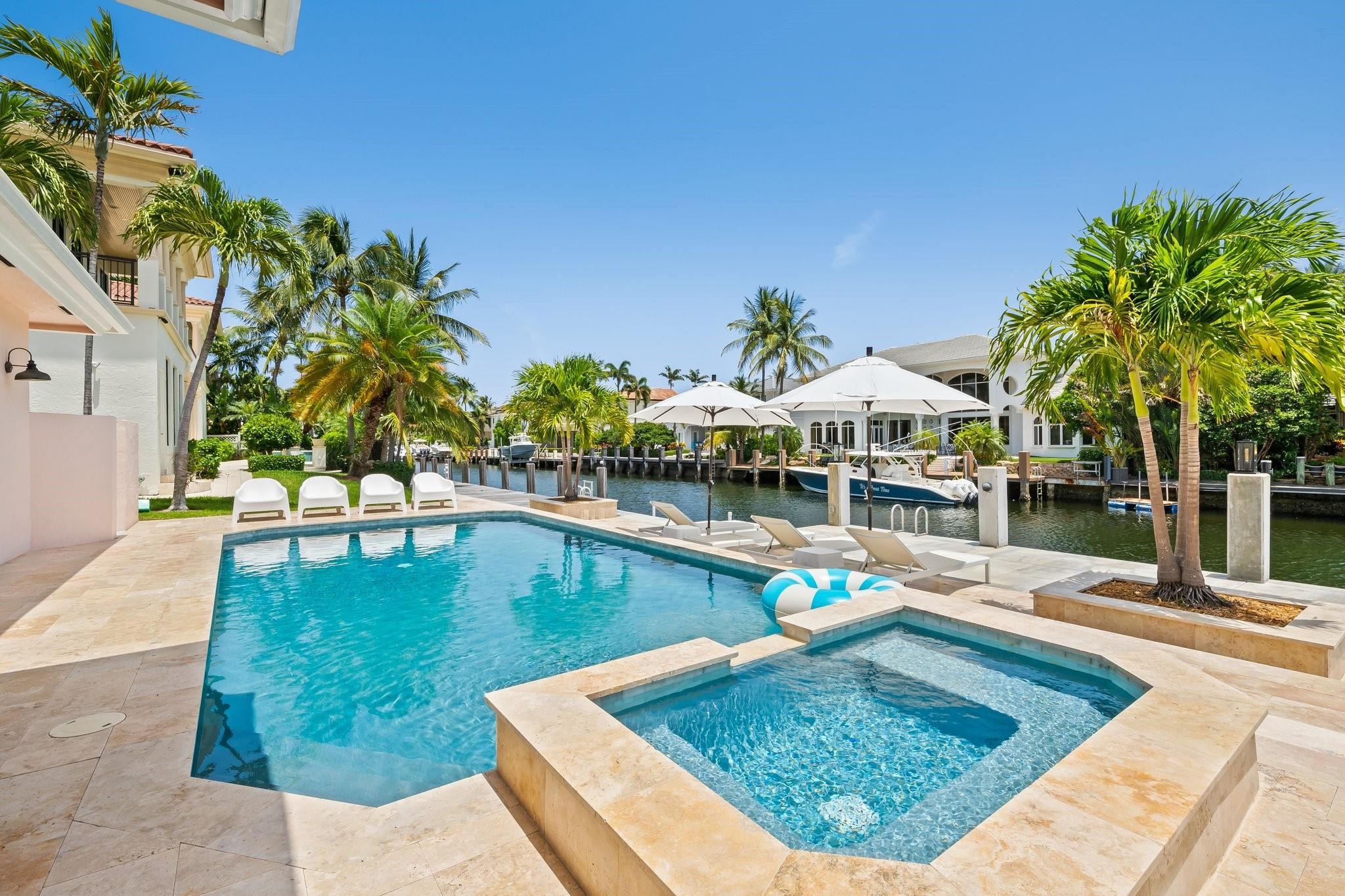 2342 Northeast 26th Street Lighthouse Point, FL 33064 - Photo 3 of 33 a view of a swimming pool with lounge chair