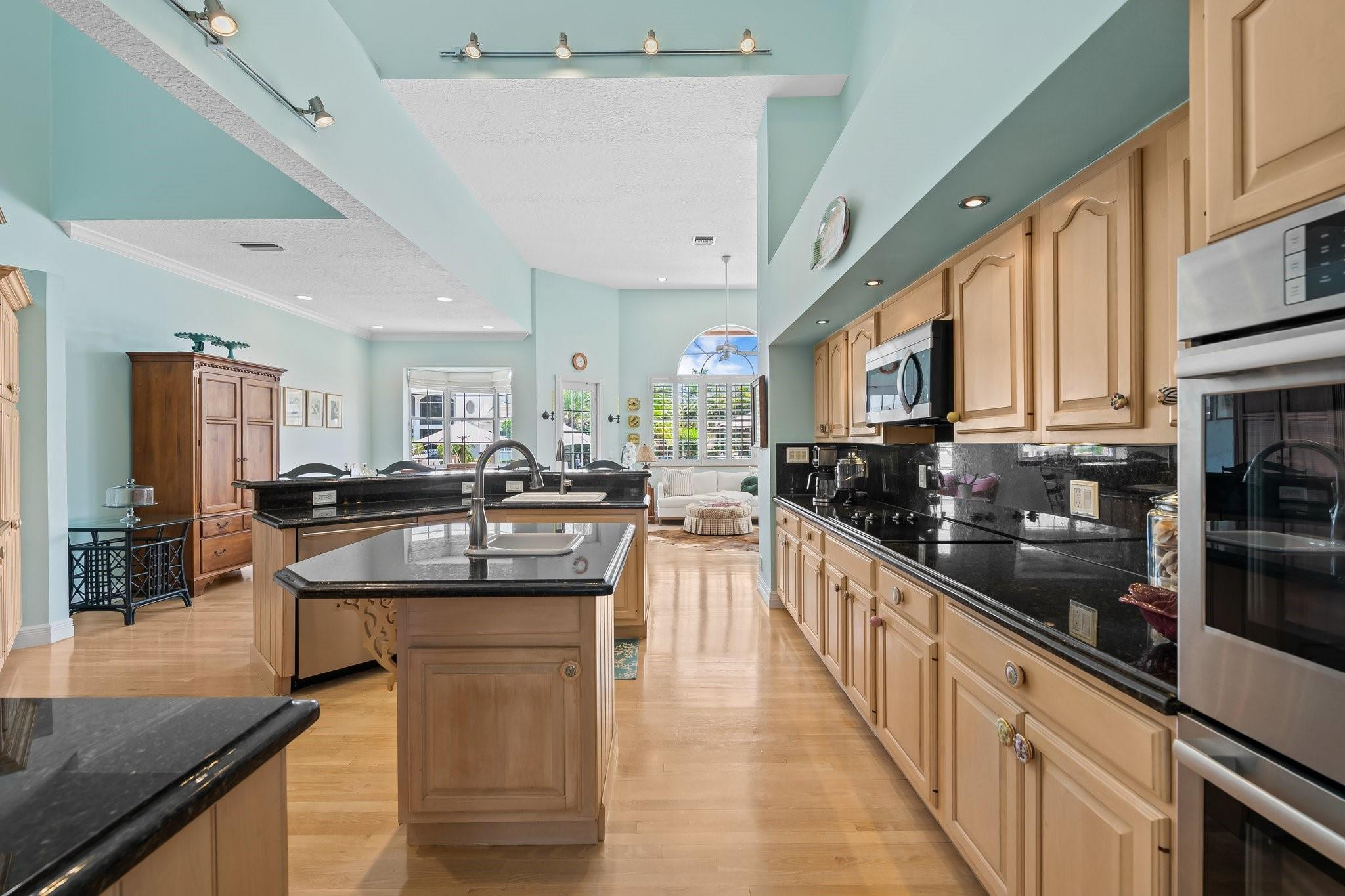 2342 Northeast 26th Street Lighthouse Point, FL 33064 - Photo 7 of 33 a kitchen with stainless steel appliances granite countertop lots of counter top space and cabinets