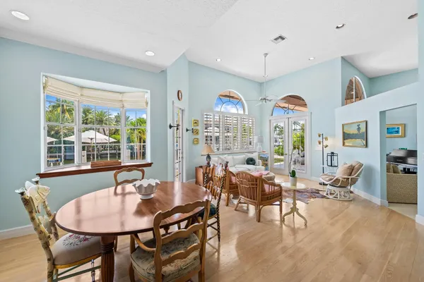 a living room with furniture chandelier and a large window