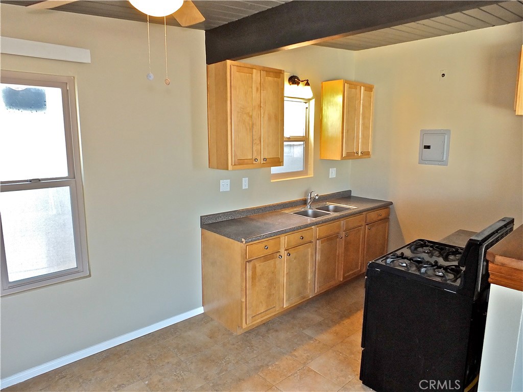17031 7th Street, Unit A Sunset Beach, CA 90742 - Photo 12 of 27 a kitchen with stainless steel appliances granite countertop a sink stove and refrigerator