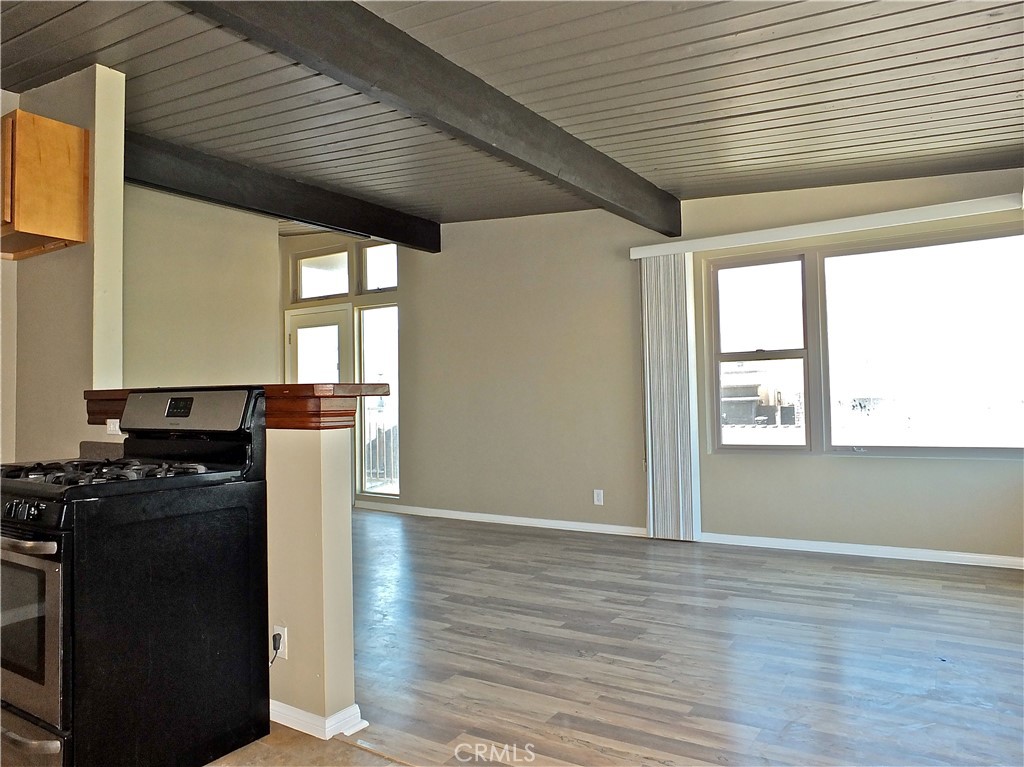 17031 7th Street, Unit A Sunset Beach, CA 90742 - Photo 16 of 27 a kitchen with a stove wooden floor and a window