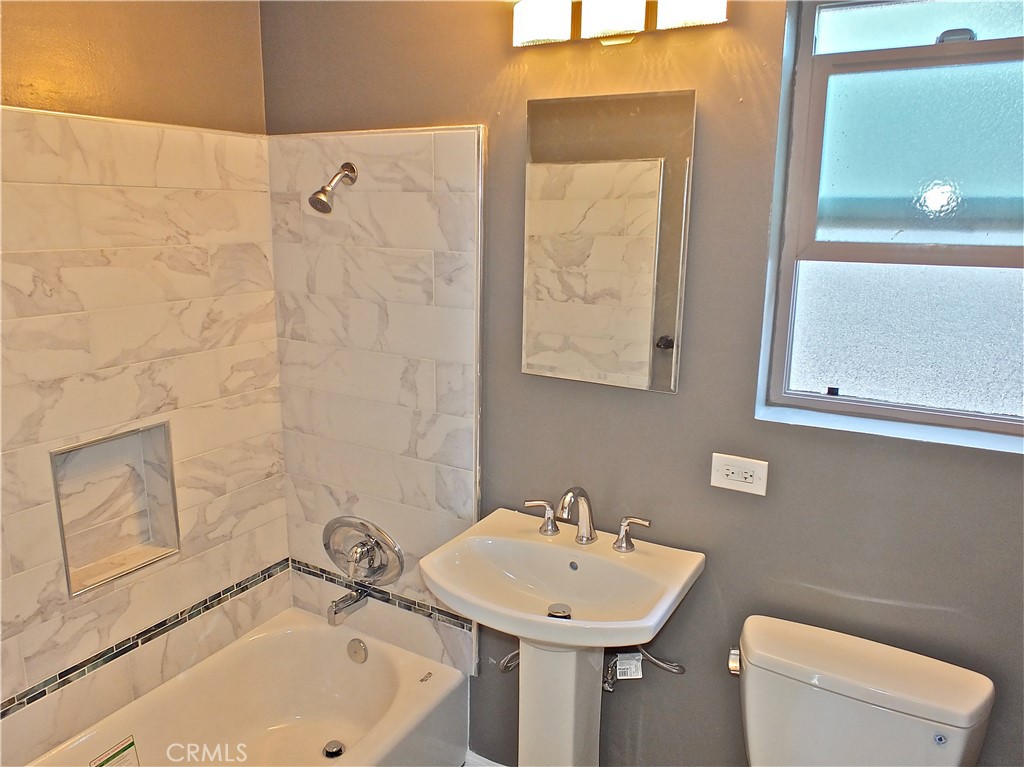 17031 7th Street, Unit A Sunset Beach, CA 90742 - Photo 22 of 27 a bathroom with a sink a toilet and shower