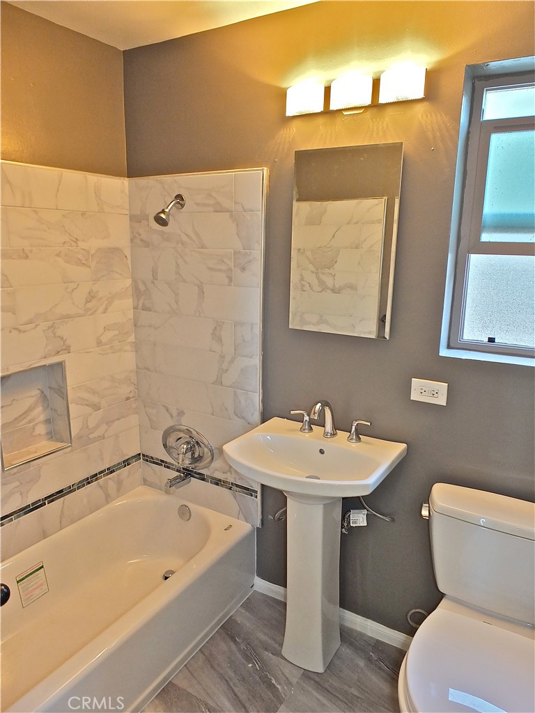 17031 7th Street, Unit A Sunset Beach, CA 90742 - Photo 23 of 27 a bathroom with a sink a toilet and mirror
