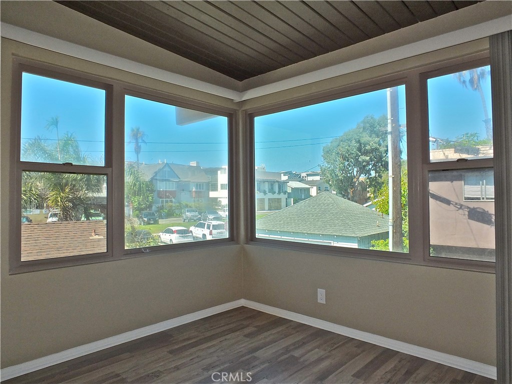 17031 7th Street, Unit A Sunset Beach, CA 90742 - Photo 25 of 27 a view of empty room with wooden floor and doors