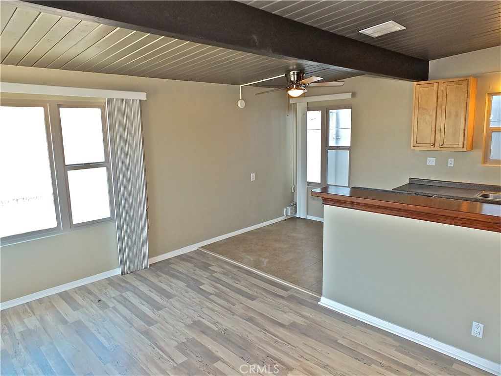 17031 7th Street, Unit A Sunset Beach, CA 90742 - Photo 9 of 27 an empty room with wooden floor and windows