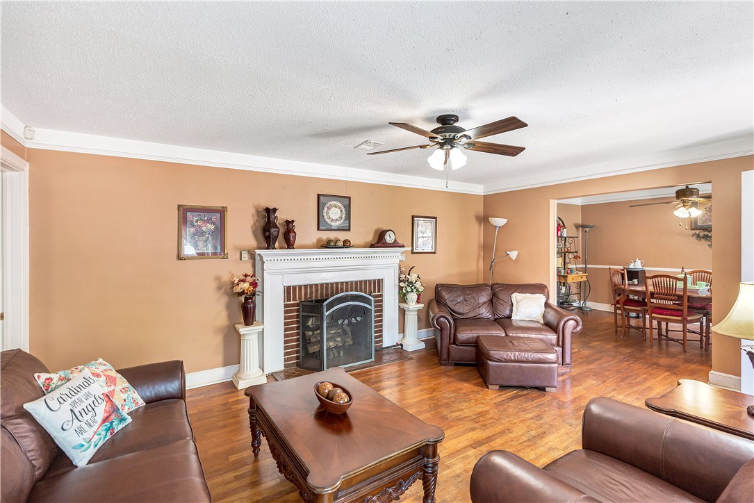 219 Beaty Square Anderson, SC 29624 - Photo 3 of 32 This inviting living area features hardwood floors and a cozy fireplace, ideal for everyday living.