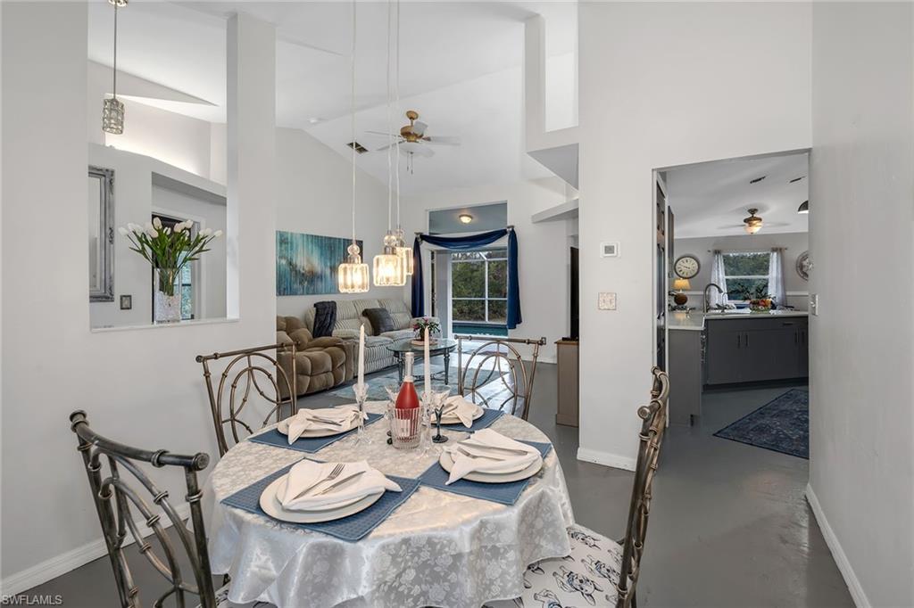 220 37th Avenue Northeast Naples, FL 34120 - Photo 18 of 49 a view of a dining room with furniture