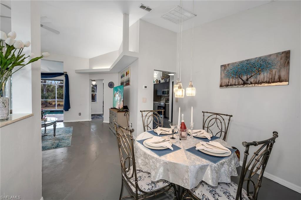 220 37th Avenue Northeast Naples, FL 34120 - Photo 19 of 49 a view of a dining room with furniture and wooden floor