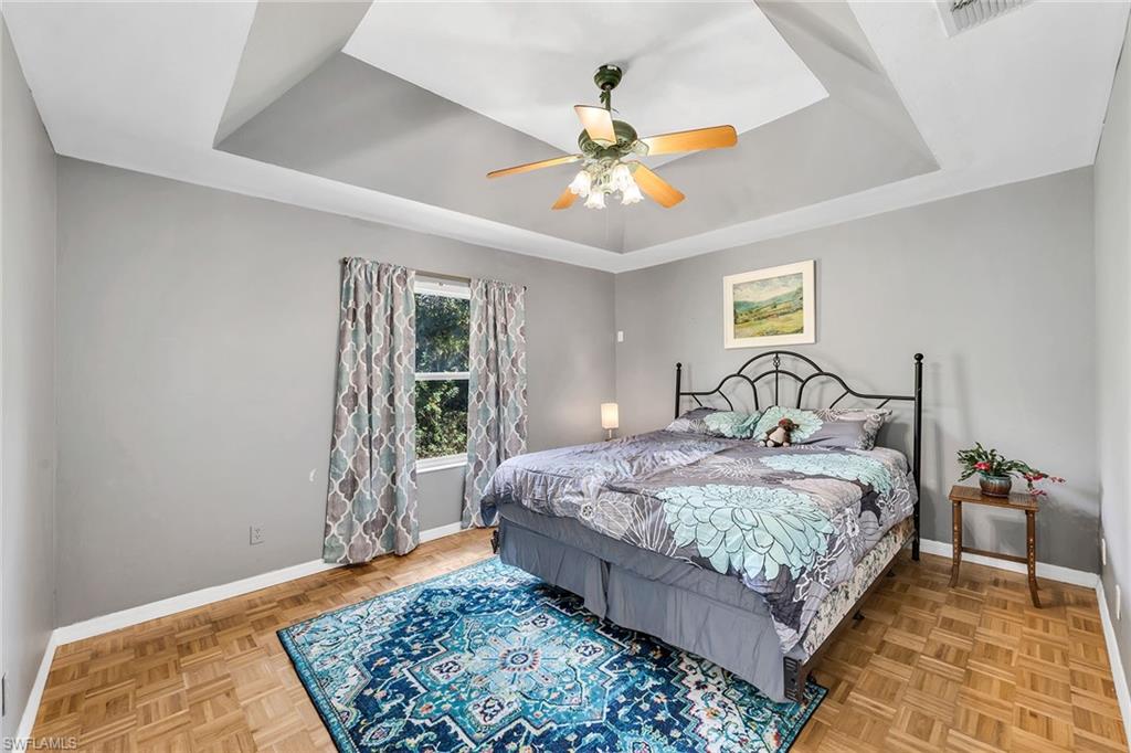 220 37th Avenue Northeast Naples, FL 34120 - Photo 23 of 49 a bedroom with a bed rug and window