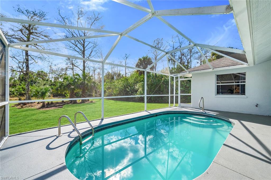 220 37th Avenue Northeast Naples, FL 34120 - Photo 34 of 49 a view of a backyard with a swimming pool