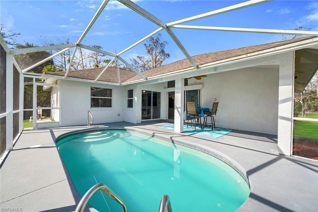 220 37th Avenue Northeast Naples, FL 34120 - Photo 35 of 49 a view of a house with pool table and chairs