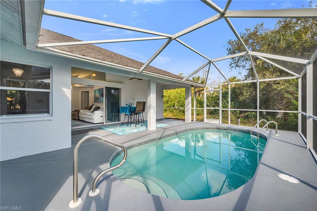 220 37th Avenue Northeast Naples, FL 34120 - Photo 36 of 49 a swimming pool with outdoor seating