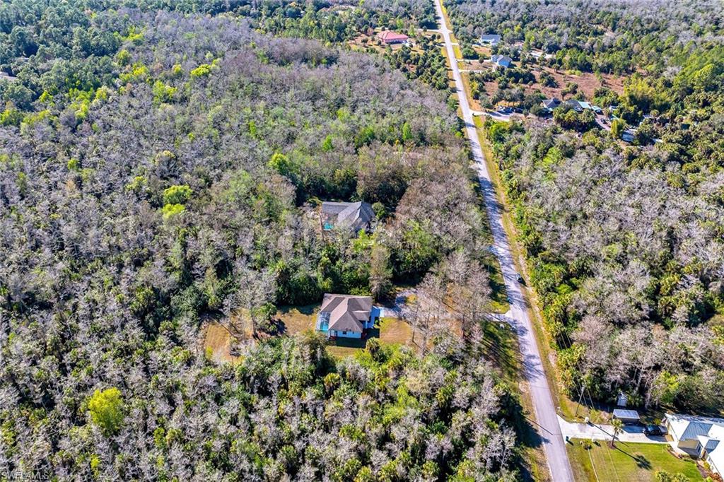 220 37th Avenue Northeast Naples, FL 34120 - Photo 39 of 49 a backyard of a house with a yard and outdoor seating