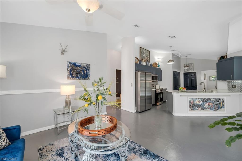 220 37th Avenue Northeast Naples, FL 34120 - Photo 4 of 49 a living room with furniture and a table