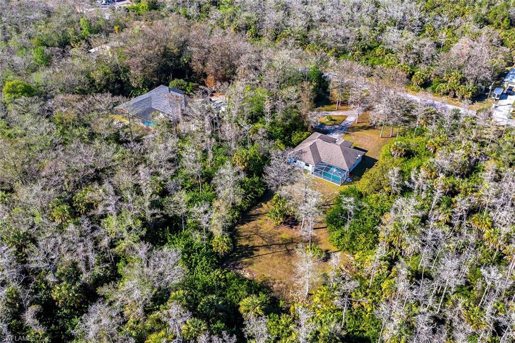 220 37th Avenue Northeast Naples, FL 34120 - Photo 41 of 49 an aerial view of house with yard and mountain view in back