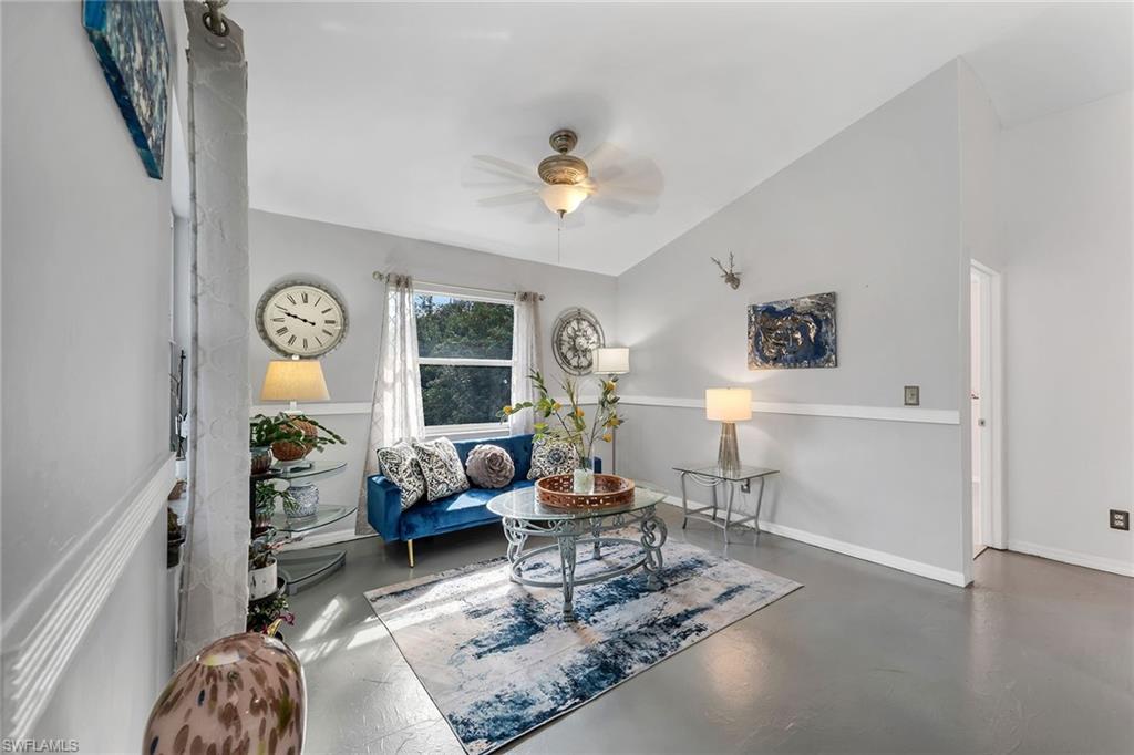 220 37th Avenue Northeast Naples, FL 34120 - Photo 5 of 49 a living room with furniture a chandelier and a window