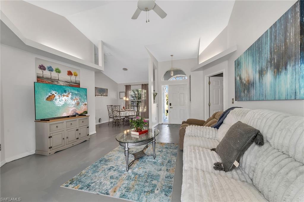 220 37th Avenue Northeast Naples, FL 34120 - Photo 9 of 49 a living room with furniture and a flat screen tv