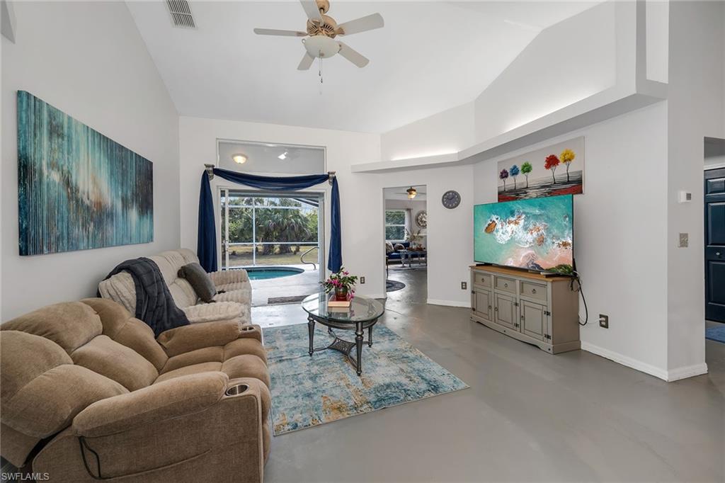 220 37th Avenue Northeast Naples, FL 34120 - Photo 10 of 49 a living room with furniture and a flat screen tv